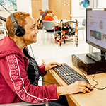 Participant at computer wearing headphones