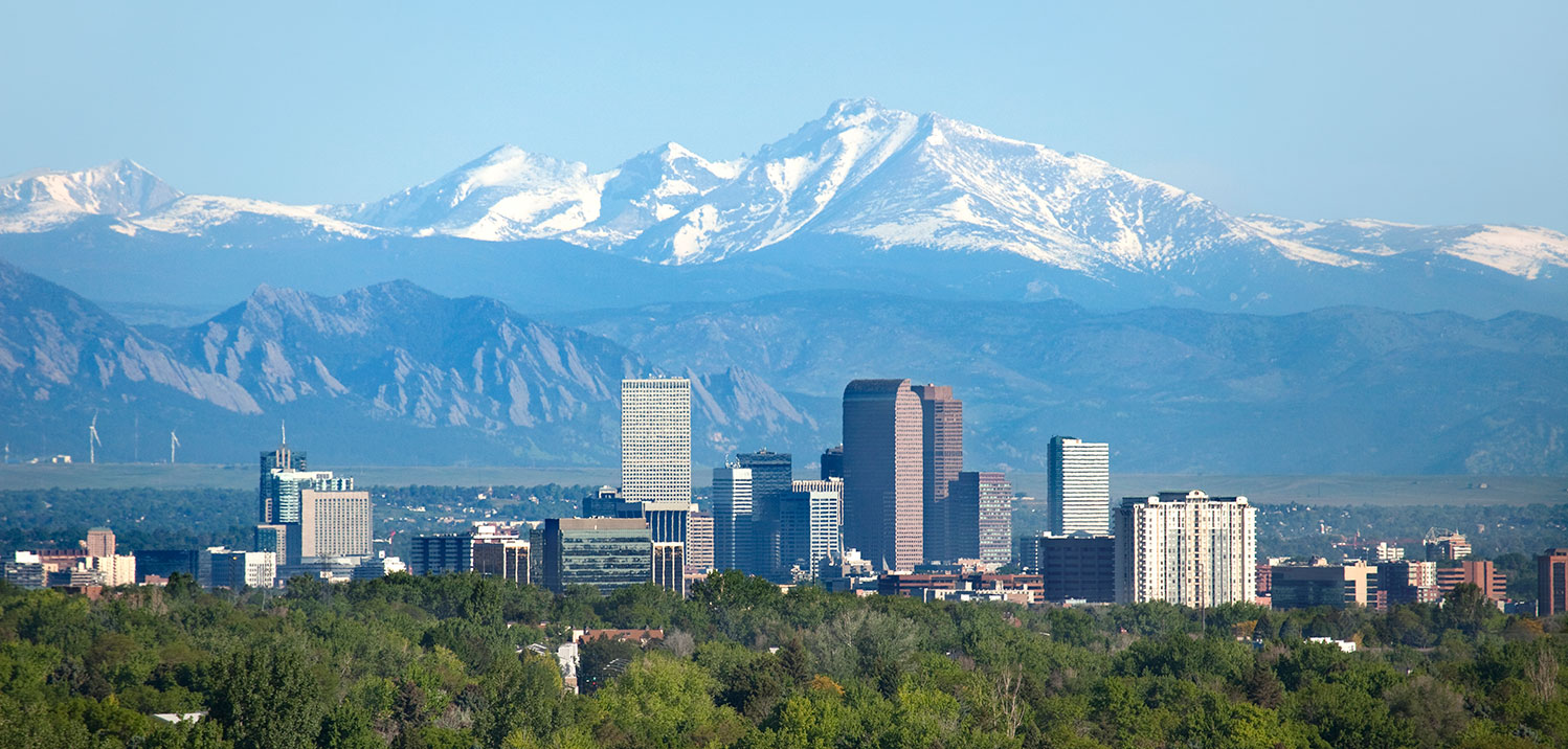 Denver skyline during the day with the Rocky Mountains in the background