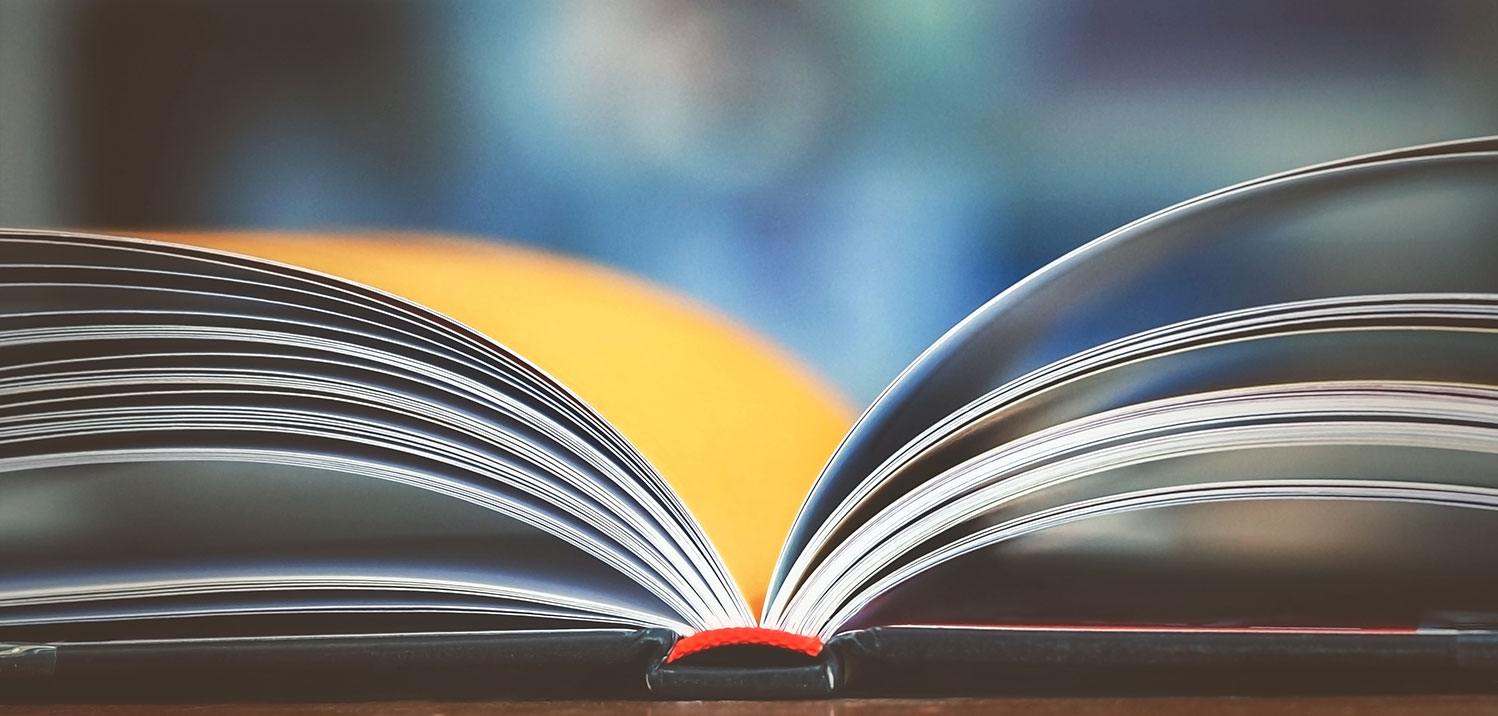 stack of books on table with blurry background