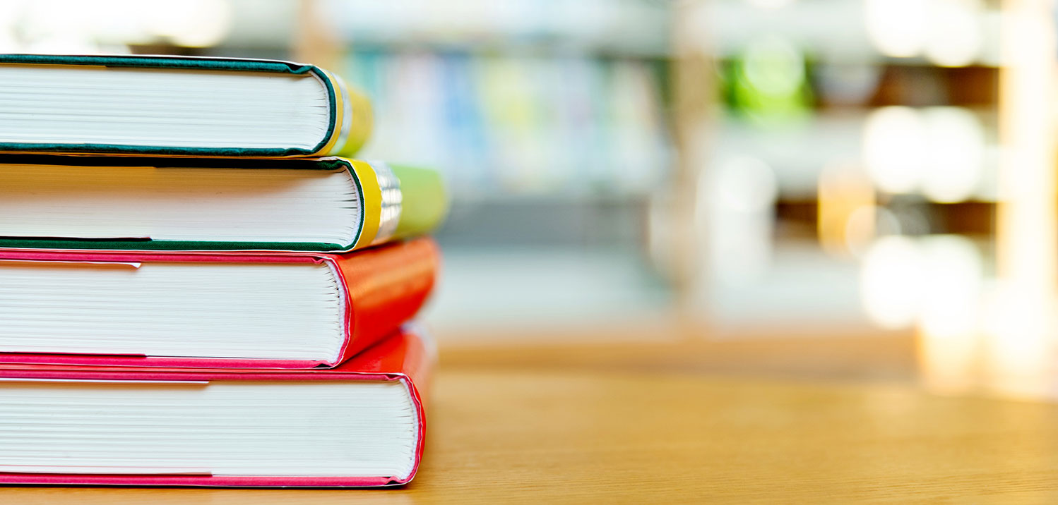 stack of books on table with blurry background