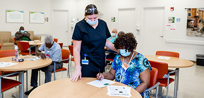 Activities director with participant in day center