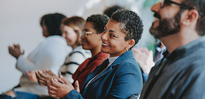 Conference attendees clapping smiling