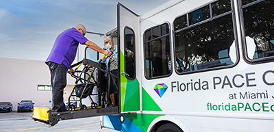 Bus driver loading or unloading participant using chair lift