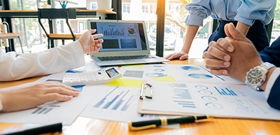 group of people at table discussing financials in office