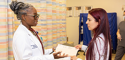 Medical director and nurse reviewing paperwork in clinic