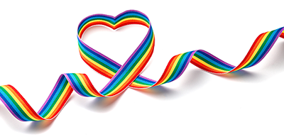 Rainbow ribbon in the shape of a heart on a white background