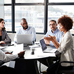 diverse colleagues sitting at conference table